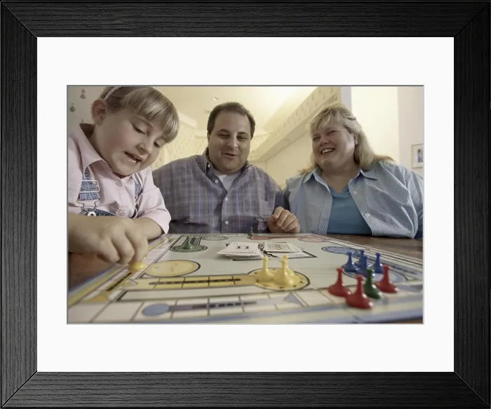 Framed Print : Parents playing with their daughter