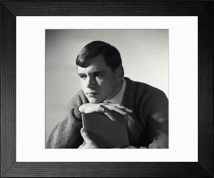 Framed Print : Close-up of a teenage boy hugging a book Framed Print : Close-up of a teenage boy hugging a book