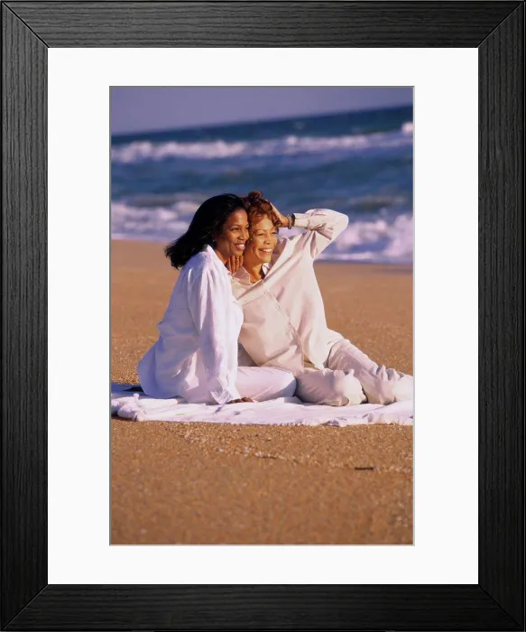 Framed Print : Mother and daughter sitting on the beach Framed Print : Mother and daughter sitting on the beach