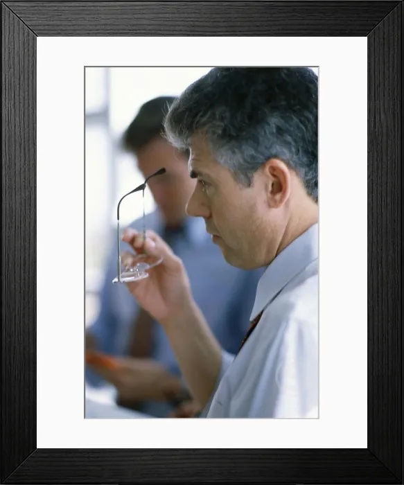 Framed Print : Side profile of a businessman holding eyeglasses Framed Print : Side profile of a businessman holding eyeglasses
