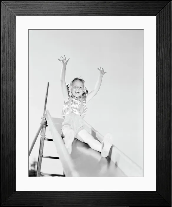 Framed Print : Low angle view of girl on slide Framed Print : Low angle view of girl on slide