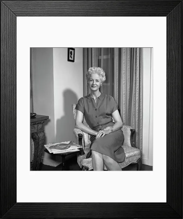 Framed Print : Portrait of mature woman sitting in armchair Framed Print : Portrait of mature woman sitting in armchair