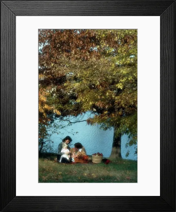 Framed Print : Mid adult couple with their child sitting at a lakeside