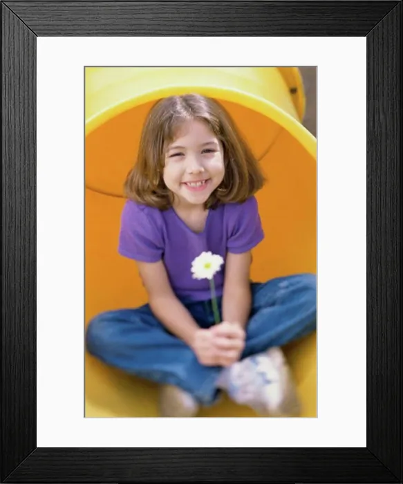 Framed Print : Girl sitting in a pipe and holding a daisy Framed Print : Girl sitting in a pipe and holding a daisy