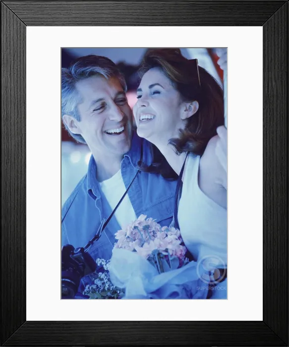 Framed Print : Mid adult man giving a bouquet of flowers to a mid adult woman Framed Print : Mid adult man giving a bouquet of flowers to a mid adult woman