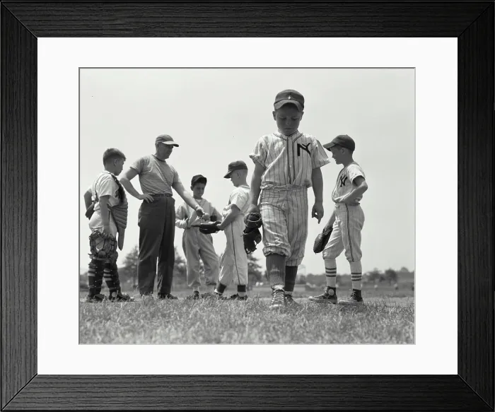 Framed Print : Boy expelled from youth league walking away from his team and coach Framed Print : Boy expelled from youth league walking away from his team and coach