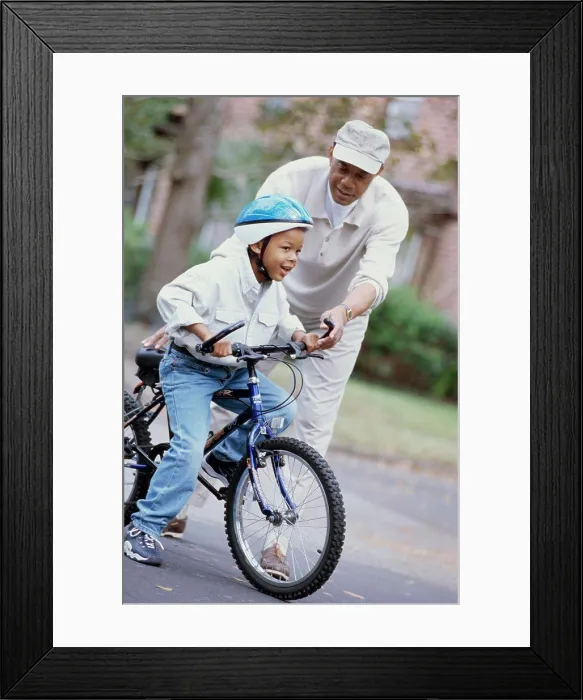 Framed Print : Grandfather teaching his grandson ride a bicycle Framed Print : Grandfather teaching his grandson ride a bicycle