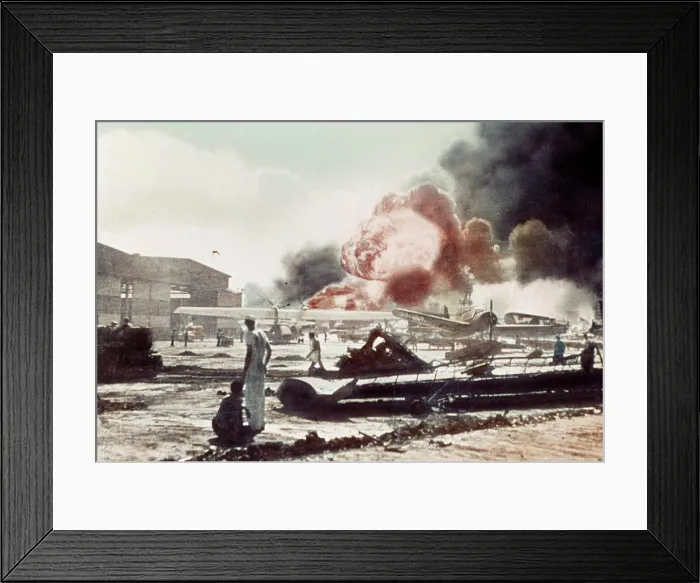Framed Print : Sailors surrounded by wrecked planes at the Ford Island Naval Air Station watch as the USS Shaw explodes Pearl Harbor
