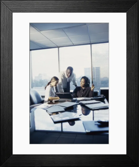 Framed Print : Three business executives working in an office Framed Print : Three business executives working in an office