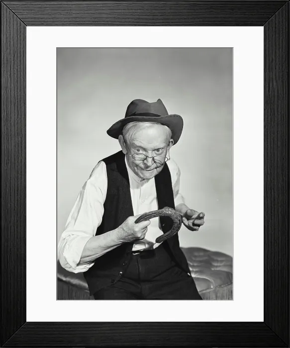 Framed Print : Vintage Photograph. Old man with glasses wearing hat and wool vest about to throw horseshoe Framed Print : Vintage Photograph. Old man with glasses wearing hat and wool vest about to throw horseshoe