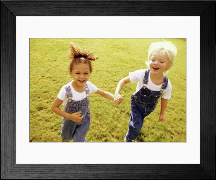 Framed Print : Portrait of two girls walking together on a lawn