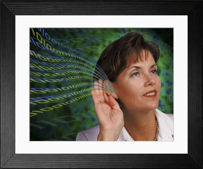 Framed Print : Businesswoman's ear with binary code flowing into it