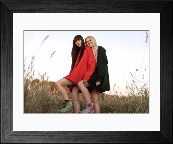 Framed Print : Fashion twin girls posing in bright clothes in the field Framed Print : Fashion twin girls posing in bright clothes in the field