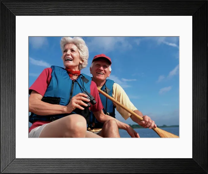 Framed Print : Low angle view of a senior couple in a row boat Framed Print : Low angle view of a senior couple in a row boat