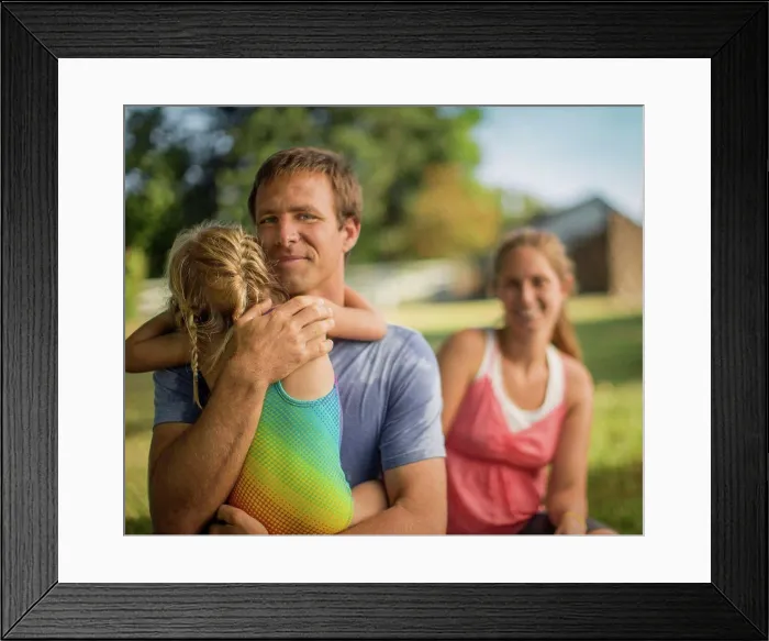 Framed Print : Portrait of a middle-aged father gently hugging his young daughter Framed Print : Portrait of a middle-aged father gently hugging his young daughter