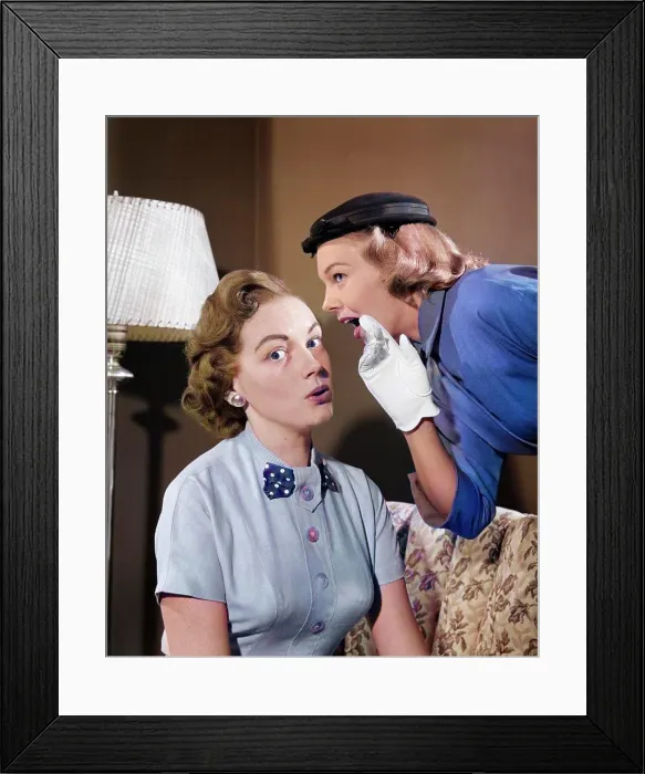 Framed Print : 1950s WOMAN IN HAT & WHITE GLOVES LEANING DOWN TO WHISPER GOSSIP TO FRIEND Framed Print : 1950s WOMAN IN HAT & WHITE GLOVES LEANING DOWN TO WHISPER GOSSIP TO FRIEND