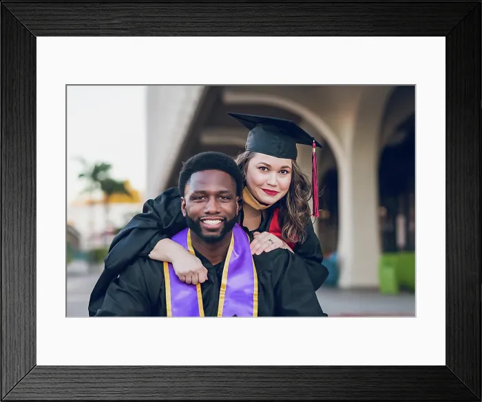 Framed Print : Young man & woman graduating college, wearing a graduation gown / cap Framed Print : Young man & woman graduating college, wearing a graduation gown / cap