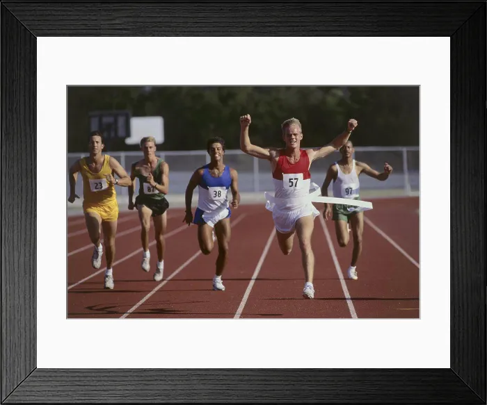 Framed Print : Male athletes running on a running track Framed Print : Male athletes running on a running track