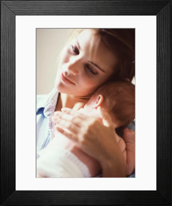 Framed Print : Close-up of a mother carrying her baby boy Framed Print : Close-up of a mother carrying her baby boy
