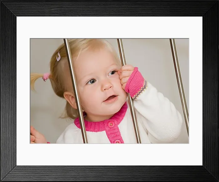 Framed Print : Blonde, 1-year old girl, behind bars Framed Print : Blonde, 1-year old girl, behind bars