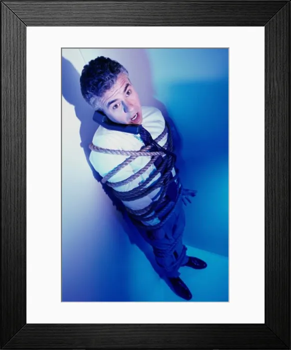 Framed Print : High angle view of a businessman bound in rope Framed Print : High angle view of a businessman bound in rope