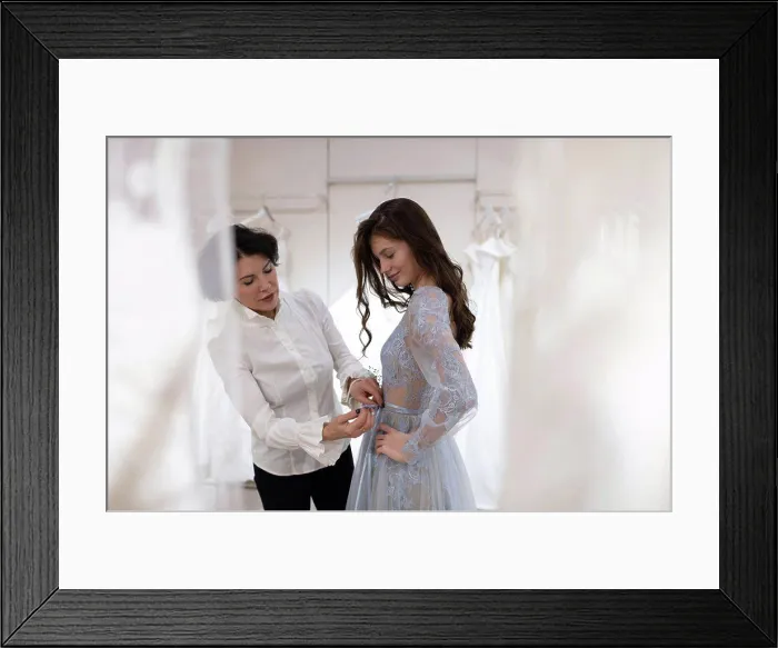 Framed Print : Happy woman fitting wedding dress in modern atelier Framed Print : Happy woman fitting wedding dress in modern atelier
