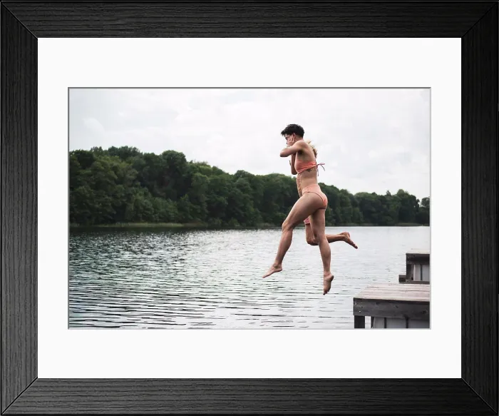 Framed Print : Friends jumping in lake in Poland in orange swimsuit in summer Framed Print : Friends jumping in lake in Poland in orange swimsuit in summer