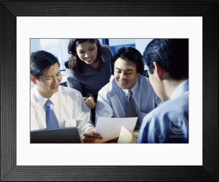 Framed Print : Businesswoman with three businessmen in an office Framed Print : Businesswoman with three businessmen in an office