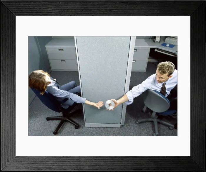 Framed Print : Businessman handing a compact disk to a businesswoman in an office Framed Print : Businessman handing a compact disk to a businesswoman in an office