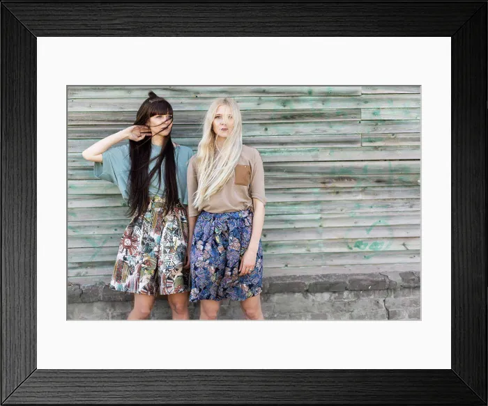 Framed Print : fashion girls twins posing in the street Framed Print : fashion girls twins posing in the street