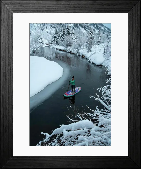 Framed Print : Woman paddleboarding on river during winter Framed Print : Woman paddleboarding on river during winter
