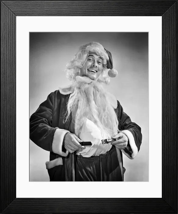 Framed Print : 1950s SMILING MAN DRESSING UP IN SANTA COSTUME HOLDING BELT AROUND PADDED STOMACH Framed Print : 1950s SMILING MAN DRESSING UP IN SANTA COSTUME HOLDING BELT AROUND PADDED STOMACH