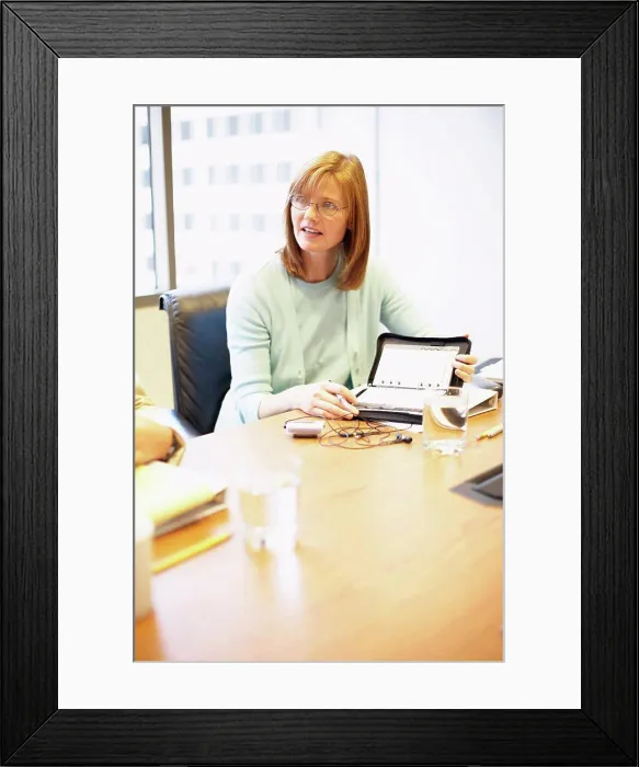 Framed Print : Businesswoman sitting in a conference room Framed Print : Businesswoman sitting in a conference room