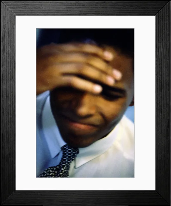 Framed Print : Close-up of a businessman with his hand on his head Framed Print : Close-up of a businessman with his hand on his head
