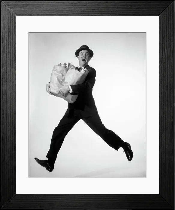Framed Print : 1950s 1960s HAPPY EXCITED MAN WEARING BUSINESS SUIT HAT CARRYING GROCERY SHOPPING BAGS RUNNING JUMPING IN AIR LOOKING Framed Print : 1950s 1960s HAPPY EXCITED MAN WEARING BUSINESS SUIT HAT CARRYING GROCERY SHOPPING BAGS RUNNING JUMPING IN AIR LOOKING