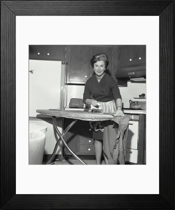 Framed Print : Portrait of a mid adult woman ironing clothes Framed Print : Portrait of a mid adult woman ironing clothes