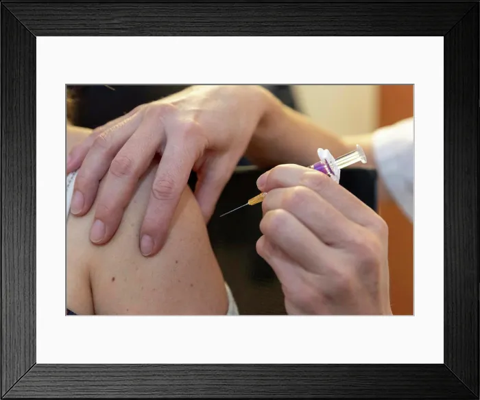 Framed Print : a caregiver is about to vaccinate a patient Framed Print : a caregiver is about to vaccinate a patient