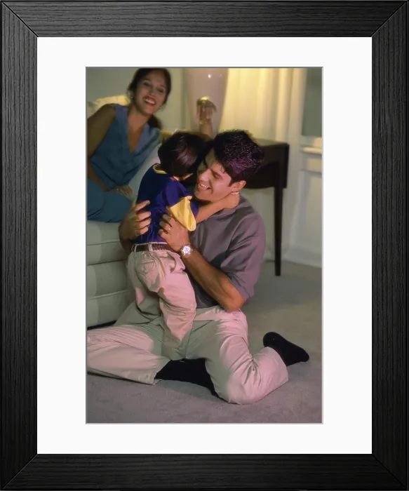 Framed Print : Mid adult man hugging his son and smiling Framed Print : Mid adult man hugging his son and smiling