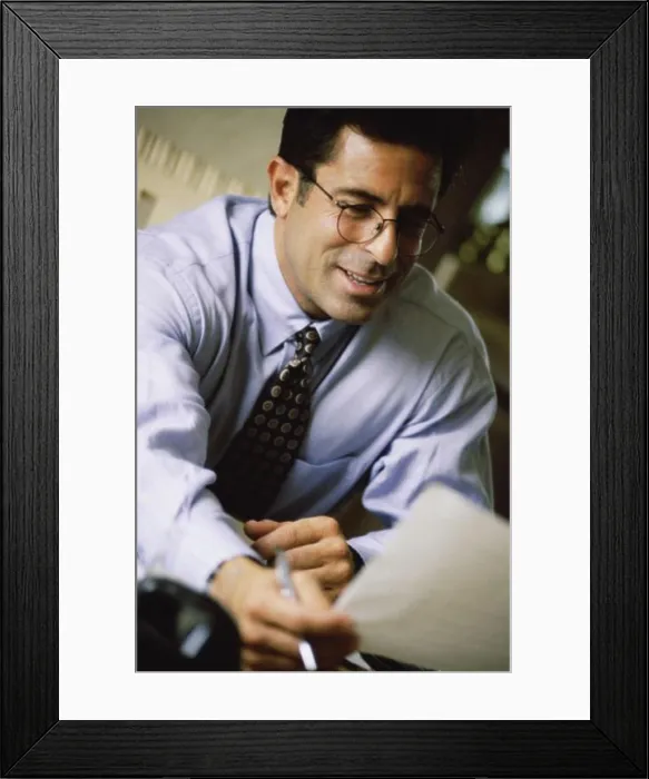 Framed Print : Businessman holding a sheet of paper Framed Print : Businessman holding a sheet of paper
