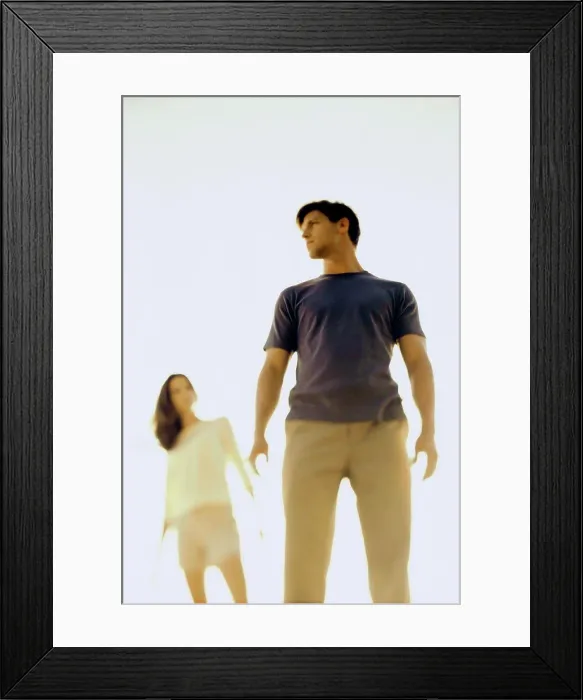 Framed Print : Low angle view of a young couple standing