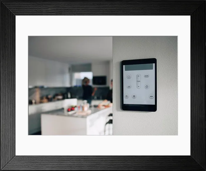 Framed Print : Thermostat app on digital tablet mounted over white wall at home