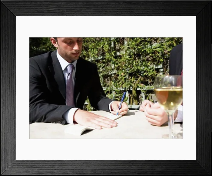 Framed Print : Close-up of a businessman signing a check Framed Print : Close-up of a businessman signing a check
