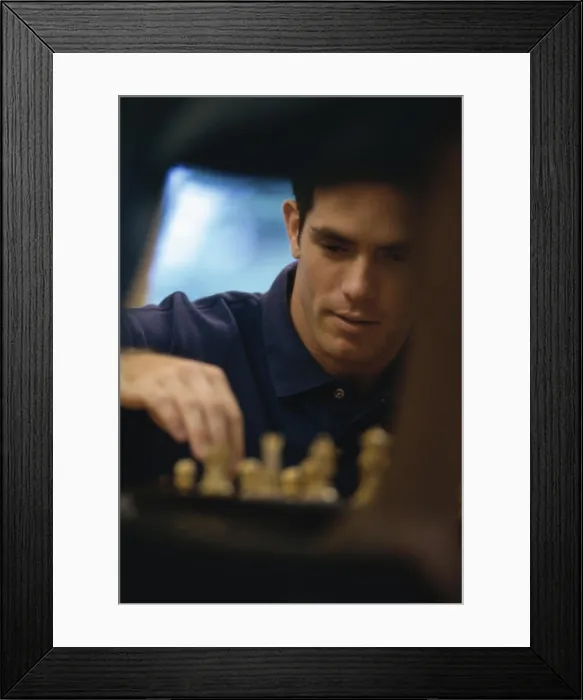 Framed Print : Young man playing chess Framed Print : Young man playing chess