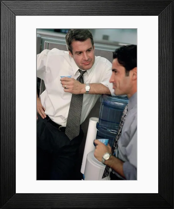 Framed Print : Two business executives talking at a water cooler Framed Print : Two business executives talking at a water cooler