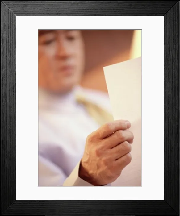 Framed Print : Businessman reading a sheet of paper Framed Print : Businessman reading a sheet of paper