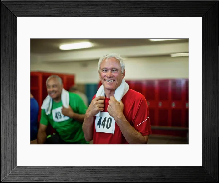 Framed Print : Portrait of a smiling senior man in a locker room