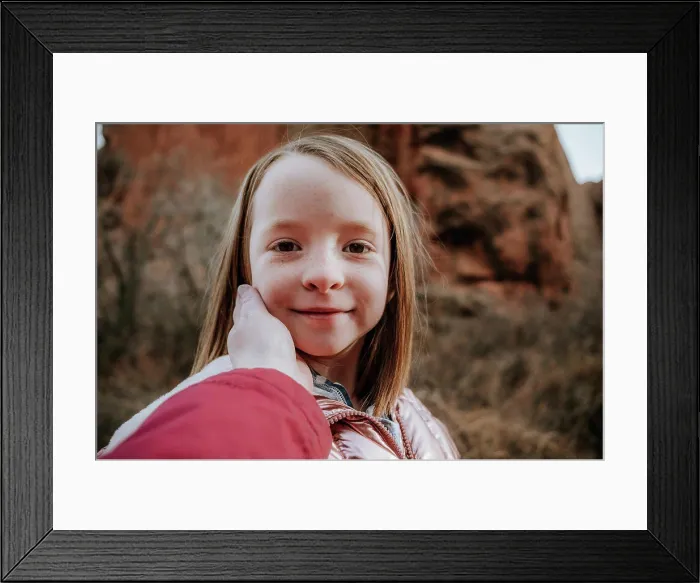 Framed Print : Happy young girl smiling while mom touches face Framed Print : Happy young girl smiling while mom touches face