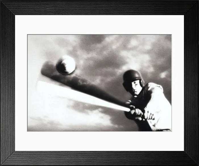 Framed Print : Low angle view of a baseball player swinging a baseball bat