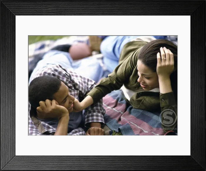 Framed Print : Young couple lying down together Framed Print : Young couple lying down together
