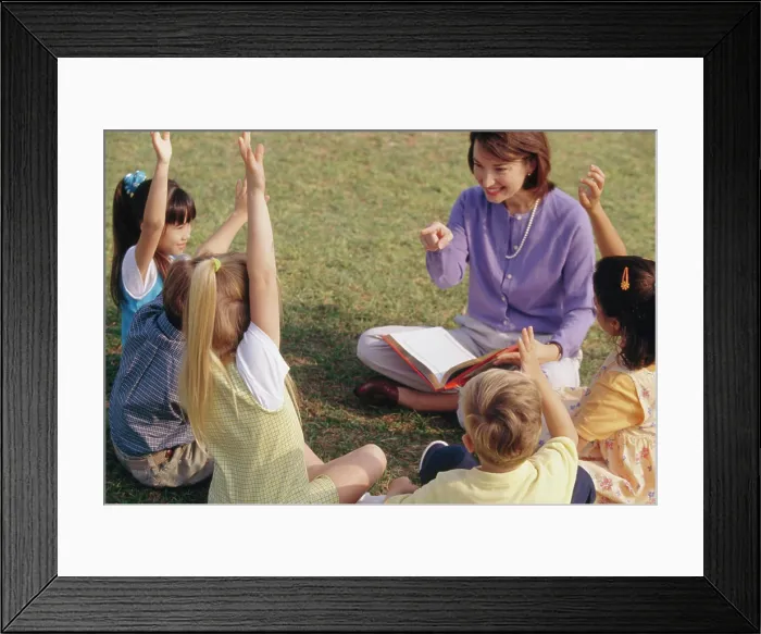 Framed Print : Female teacher playing with her students